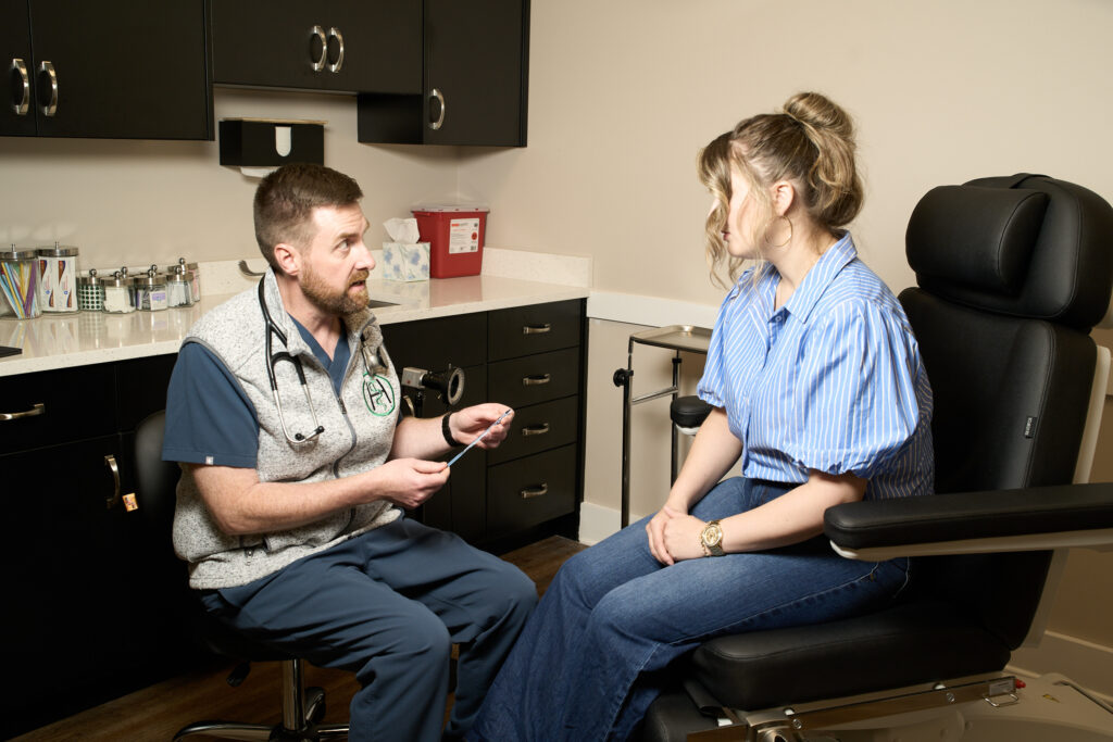 Dr. Hitchcock explaining a gentle colposcopy instrument to a patient.